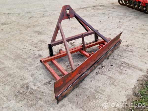 Front mounted yard scraper