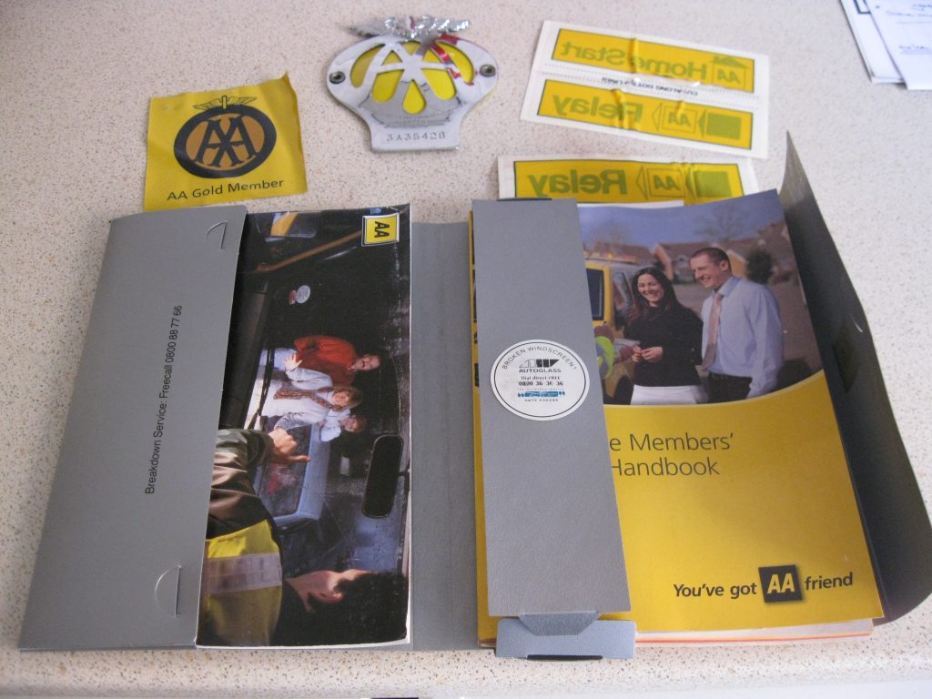 Complete AA Gold membership pack with original unused grill badge, windscreen stickers, membership book and breakdown recovery booklet