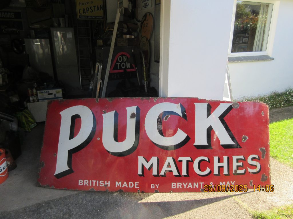 Puck Matches enamel sign