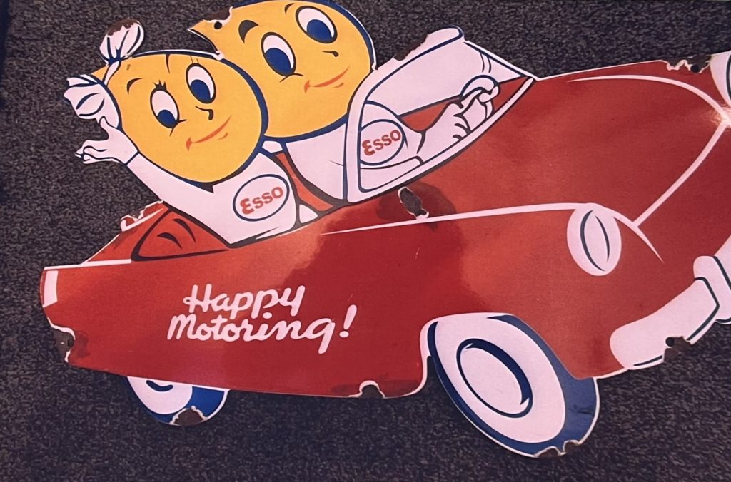 Esso Happy Motoring Oil Drip Lady & Man In Car Enamel Sign